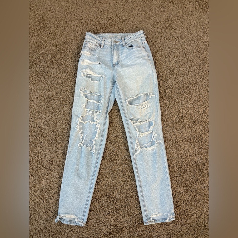 Woman’s American Eagle Outfitters high-waisted light Strigid ripped mom jeans